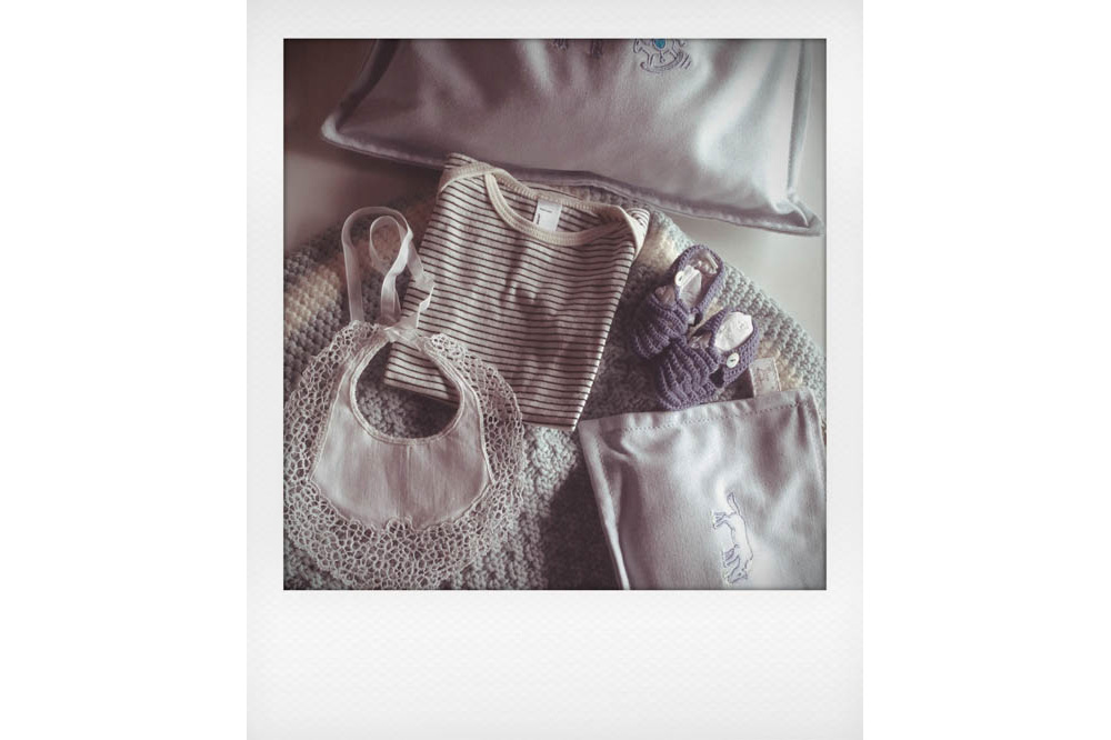 Grandma's handmade blanket, Eugeoni's Dad's lace bib, American Apparel striped onesie, Hermès pouches, and Normandie hand crochet sandals